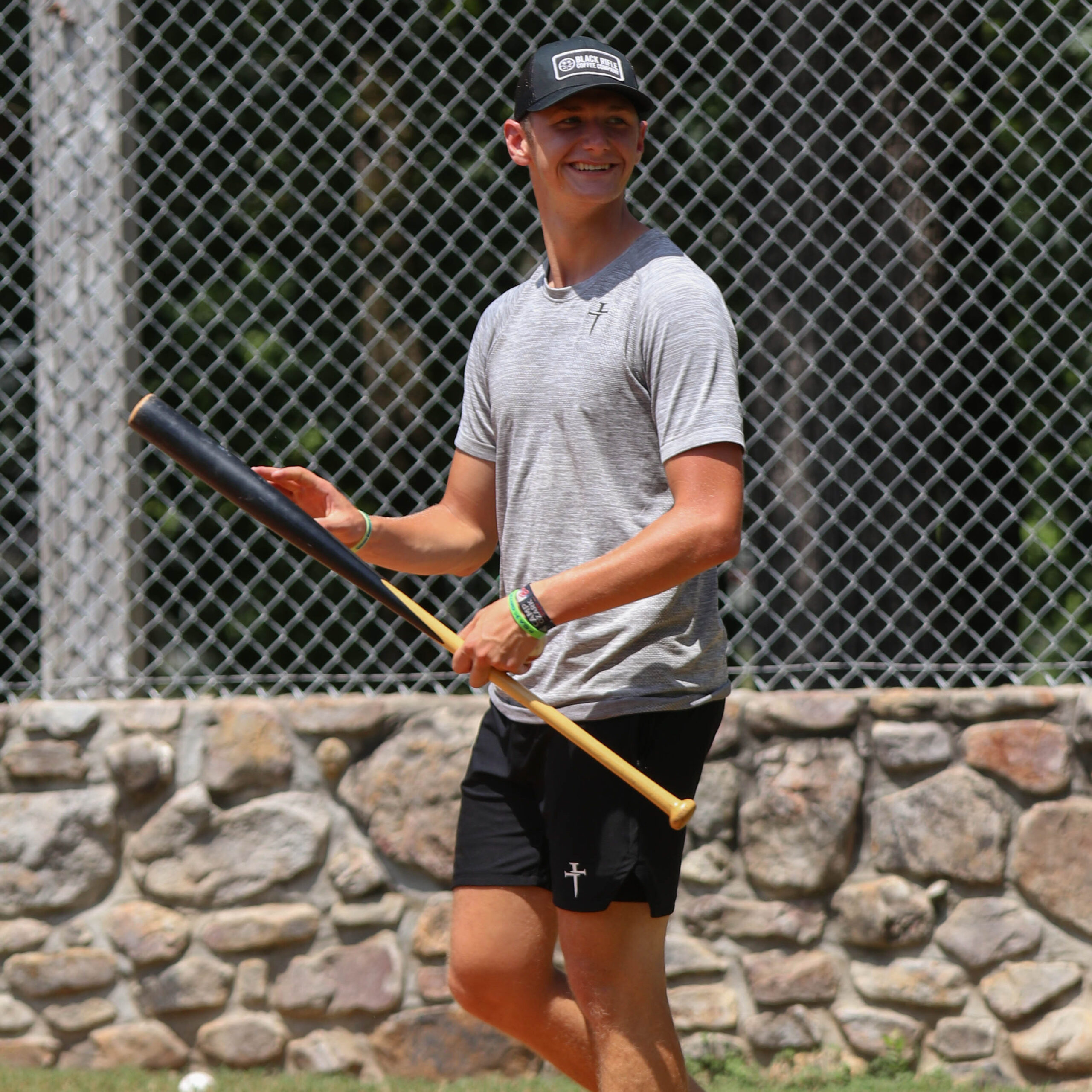 A Southern Arkansas student playing baseball at summer camp.