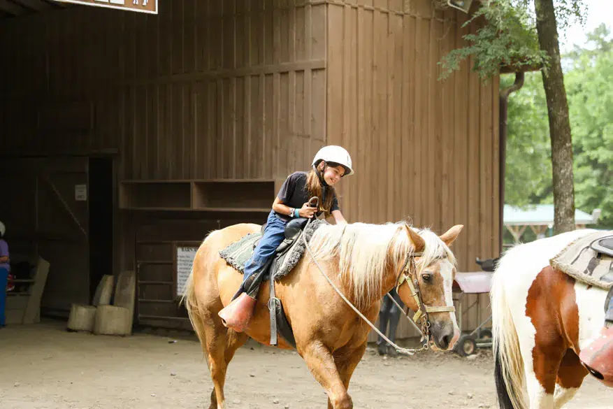 Camper riding a horse